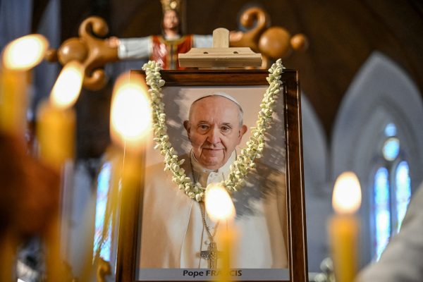 Foto von Papst Franzikus mit Kerzen im Vordergrund