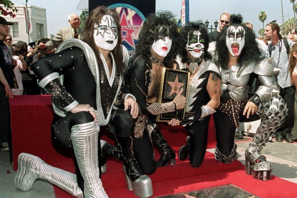 Ace Frehley, Paul Stanley, Peter Criss und Gene Simmons knien auf einem roten Teppich auf dem Hollywood Walk Of Fame